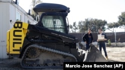 Bichen Wu and Ed Walker use a computer to examine what a self-driving bulldozer is seeing at Built Robotics in San Francisco.