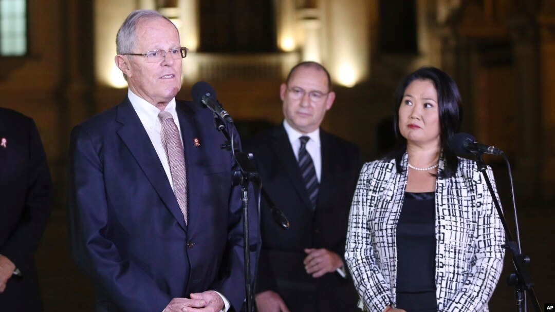 Peru's President Pedro Pablo Kuczynski, left,speaks as opposition leader and daughter of Peru's jailed former President Alberto Fujimori, Keiko Fujimori, right, looks on after their meeting at government palace in Lima, Peru, July, 11, 2017.
