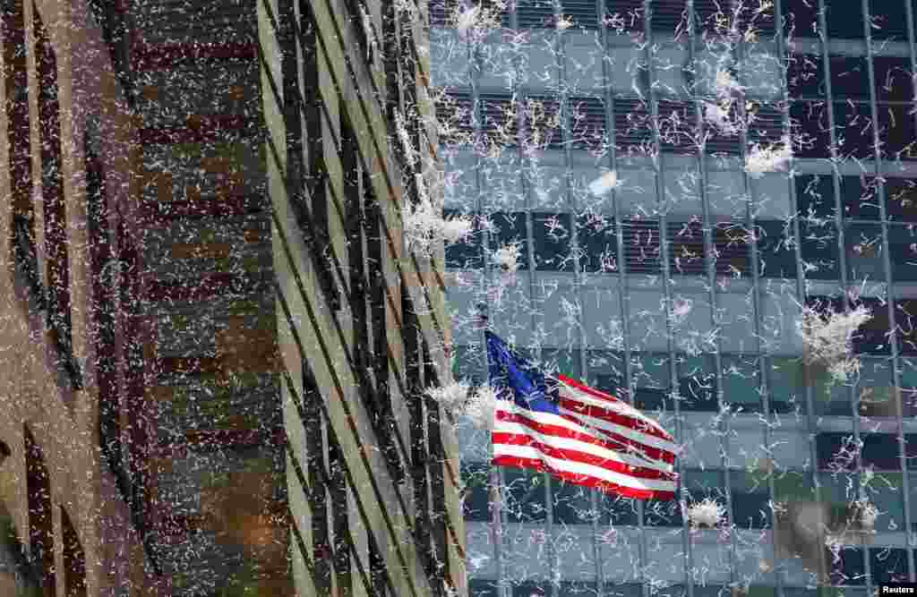 Paper falls from buildings during the ticker-tape parade for the U.S. women&#39;s soccer team up Broadway in lower Manhattan to celebrate their World Cup final win over Japan in New York, July 10, 2015.