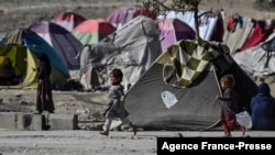 FILE - Internally displaced Afghan children play at the Saray Shamali IDP camp in Kabul, Afghanistan, Nov. 2, 2021. An aid agency said Tuesday that Afghanistan's Taliban authorities evicted about 1,700 people from a makeshift settlement in Kabul and demolished it.