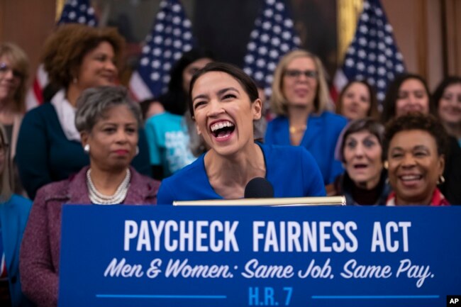 Rep. Alexandria Ocasio-Cortez, D-N.Y., smiles as she speaks at an event to advocate for the Paycheck Fairness Act on the 10th anniversary of President Barack Obama signing the Lilly Ledbetter Fair Pay Act.