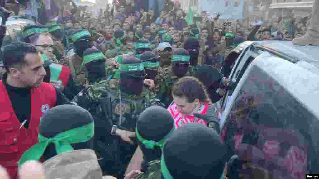 Palestinian Hamas militants hand over hostages kidnapped during the Oct. 7, 2023, attack on Israel, to members of the International Committee of the Red Cross (ICRC)&nbsp;as part of a ceasefire and a hostages-prisoners swap deal between Hamas and Israel,&nbsp;in Gaza City, Jan. 19, 2025 in this screen grab from a video.