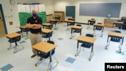 Fairfax County Public Schools assistant director of facilities management Todd Jones stands in a classroom where desks have been spaced to prevent the spread of the coronavirus disease (COVID-19) at Mantua Elementary School in Fairfax, Virginia, U.S., July 17, 2020. REUTERS