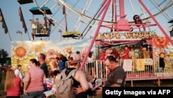 People attend a county fair Aug. 6, 2021, in Rolla, Missouri. The state health department says only a little more than 4 in 10 Missourians have received the COVID vaccine as the pandemic continues to infect thousands.
