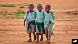 FILE - Young schoolboys walk home in the village of Nyumbani, Kenya, which caters to children who lost their parents to HIV, and grandparents who lost their children to HIV.