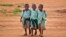 FILE - Young schoolboys walk home in the village of Nyumbani, Kenya, which caters to children who lost their parents to HIV, and grandparents who lost their children to HIV.