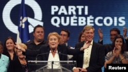 Parti Quebecois leader Pauline Marois stands with her family after winning a minority government in the Quebec provincial election in Montreal, Quebec, September 4, 2012. 