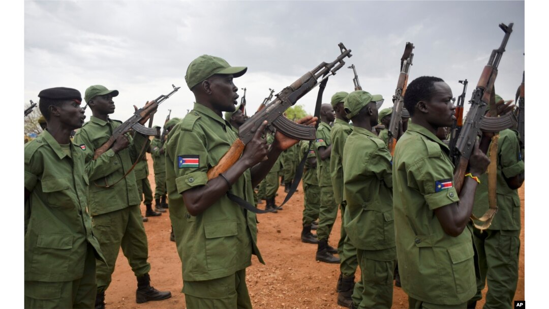 FILE - South Sudanese rebel soldiers raise their weapons at a military camp in the capital Juba, South Sudan, Thursday, April 7, 2016.