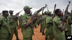 FILE - South Sudanese rebel soldiers raise their weapons at a military camp in the capital Juba, South Sudan, April 7, 2016. Some 750 of them are now on DRC territory.