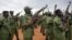 FILE - South Sudanese rebel soldiers raise their weapons at a military camp in the capital Juba, South Sudan, April 7, 2016. Some 750 of them are now on DRC territory.