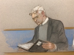 Julian Assange is seen in court during a hearing to decide whether he should be extradited to the United States, in London, Feb. 24, 2020 in this courtroom sketch.