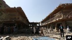 Afghans gather at the site of a car bomb attack in Kabul, Afghanistan, Aug. 7, 2015. 