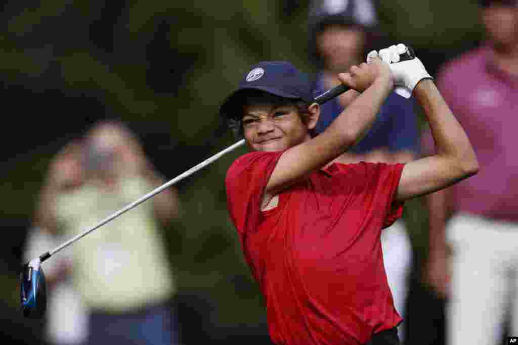 Charlie Woods, son of Tiger Woods, watches his shot on the first tee during the second round of the PNC Championship golf tournament in Orlando, Florida.