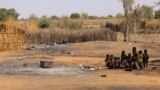 FILE - Sudanese children sit together following violence in Sudan's Darfur region, Feb. 2, 2021.