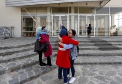 Students of American University of Afghanistan greet each other as they arrive for orientation sessions at American University in Kabul, March 27, 2017.