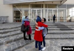 Students of American University of Afghanistan greet each other as they arrive for orientation sessions at American University in Kabul, March 27, 2017.