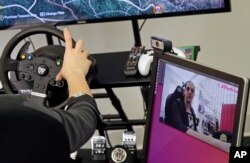 Ashley McManus, global marketing director of the Boston-based artificial intelligence firm Affectiva, demonstrates facial recognition technology that is geared to help detect driver distraction, at the company's offices in Boston, April 23, 2018.