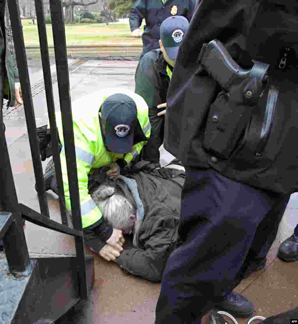 Capitol Police arrest William Griffin as "occupy Congress" protesters are moved out of a restricted area on the West Lawn on Capitol Hill in Washington, Tuesday, Jan. 17, 2012. (AP Photo/J. Scott Applewhite)