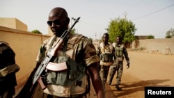 FILE - Soldiers from the Waraba Battalion, an EU-trained Malian army battalion, walk outside their base in Gao, July 8, 2013.