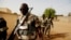 FILE - Soldiers from the Waraba Battalion, an EU-trained Malian army battalion, walk outside their base in Gao, July 8, 2013.