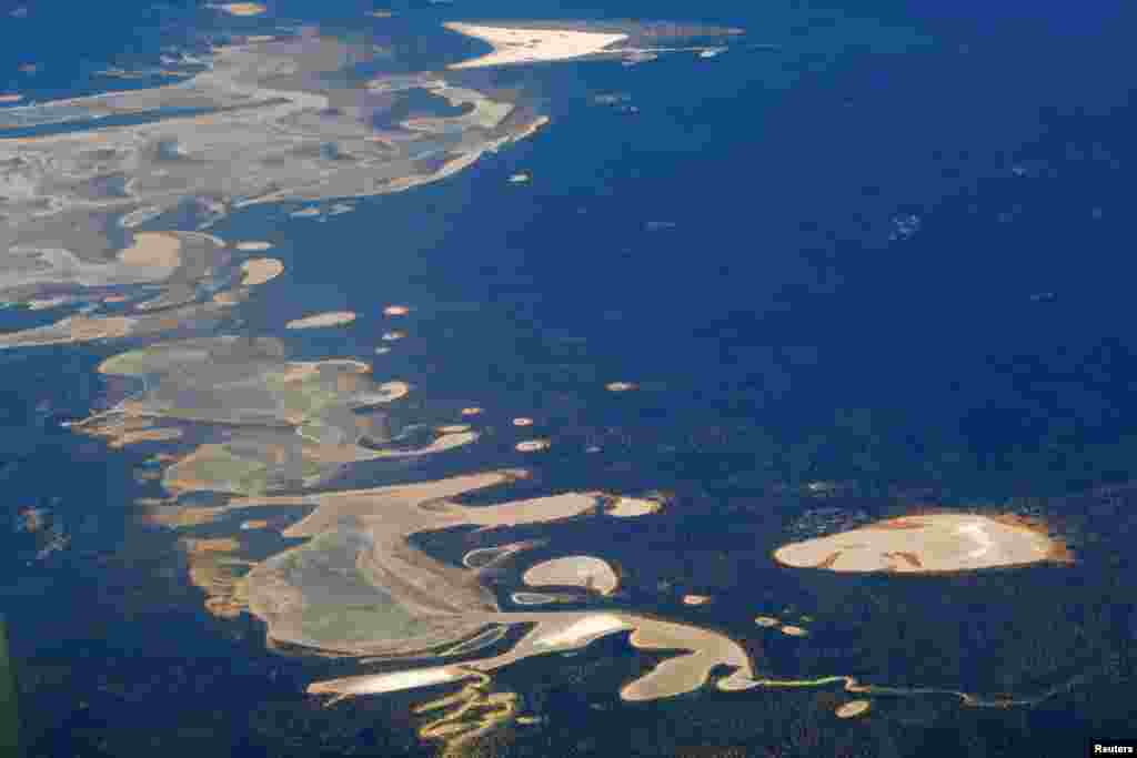 Salt lakes partially filled with water can be seen near farmland located east of the city of Perth in Australia.