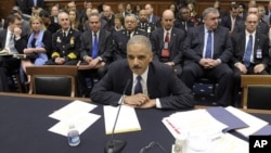 Attorney General Eric Holder, with local law enforcement officers behind him, including Baltimore Police Commissioner Frederick H. Bealefeld, third from left, and Philadelphia Police Commissioner Charles Ramsey, center, prepares to testify on Capitol Hill