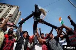 FILE - People burn an effigy depicting Pakistan as they celebrate after Indian authorities said their jets conducted airstrikes on militant camps in Pakistani territory, in Ahmedabad, India, Feb. 26, 2019.