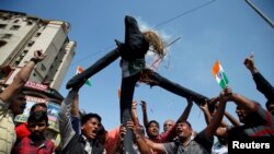 People burn an effigy representing Pakistan as they celebrate after Indian officials said their airplanes carried out airstrikes on militant camps in Pakistani territory, in Ahmedabad, India, February 26, 2019. 