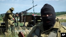 Pro-Russian fighters stand in their positions as they patrol the airspace near Luhansk, eastern Ukraine, July 2, 2014. 
