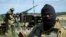 Pro-Russian fighters stand in their positions as they patrol the airspace near Luhansk, eastern Ukraine, July 2, 2014. 