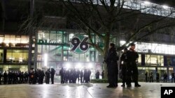 Police officers stand outside the HDI-Arena stadium as the soccer friendly match between Germany and the Netherlands was cancelled in Hannover, Germany, Nov. 17, 2015. 