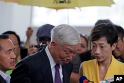 Occupy Central leader Chu Yiu-ming, center, cries as he speaks to media after sentencing at a court in Hong Kong, Wednesday, April 24, 2019.