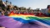 Para peserta pawai menggelar bendera pelangi di "Parade Kesetaraan" untuk mendukung komunitas LGBT di Lublin, Polandia, 13 Oktober 2018.