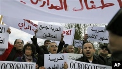 Syrian immigrants shout slogans in front of the Syrian embassy in Sofia, Bulgaria, to protest Syrian president Bashar al-Assad after violence was used on a group of anti-governmental protesters who allegedly were tortured and held hostage in Syria, March 