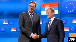 Serbia's President Aleksandar Vucic (L) shakes hands with European Union Council President Donald Tusk following their meeting at the European Union Council in Brussels on July 14, 2017.
