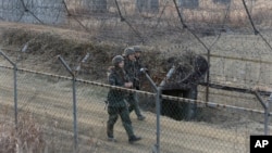 South Korean army soldiers patrol the barbed-wire fence in Paju, near the border with North Korea, South Korea, Wednesday, Jan. 6, 2016.