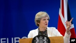 FILE - British Prime Minister Theresa May speaks during a media conference at an EU summit in Brussels on Oct. 20, 2017.