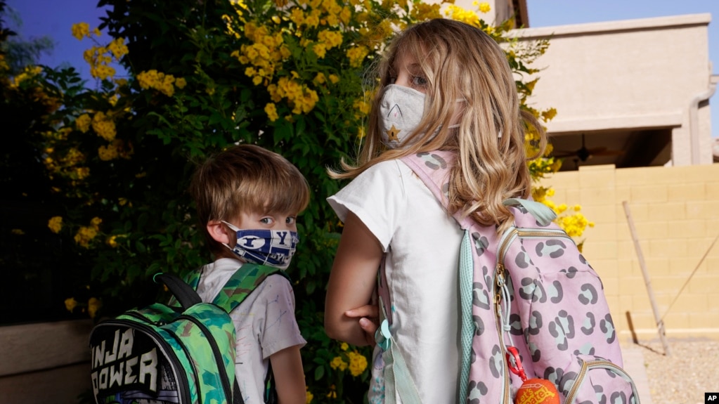 Angela Black, right, with her brother Luke Black at their home, pose for a photo Tuesday, May 11, 2021, in Mesa, Ariz. (AP Photo/Ross D. Franklin)