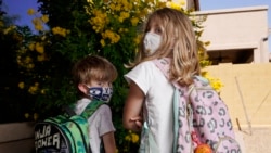 Angela Black, right, with her brother Luke Black at their home, pose for a photo Tuesday, May 11, 2021, in Mesa, Ariz. (AP Photo/Ross D. Franklin)