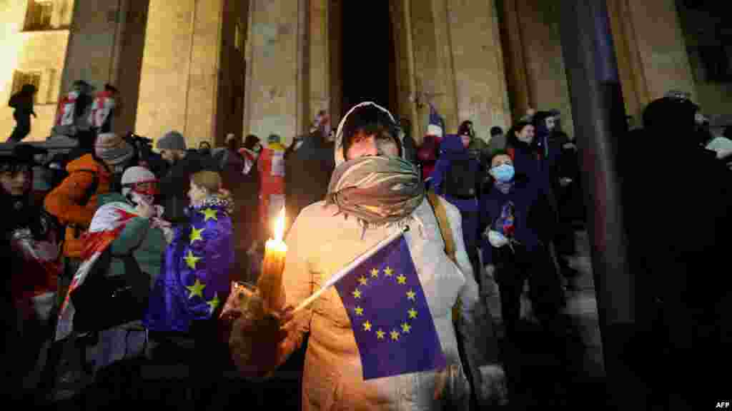 People gather to protest near the Parliament building in Tbilisi, Georgia, to oppose the government's decision to delay European Union accession negotiations until 2028.