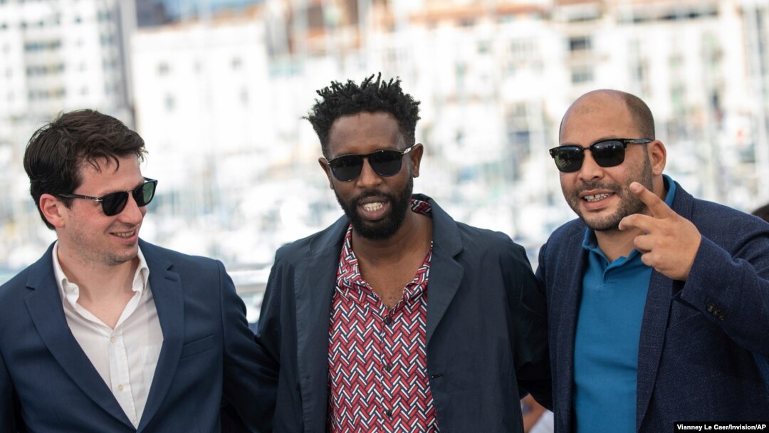 Producer Christophe Barral, from left, director Ladj Ly and producer Toufik Ayadi pose for photographers at the photo call for the film 'Les Miserables' at the 72nd international film festival, Cannes, southern France, May 16, 2019. 