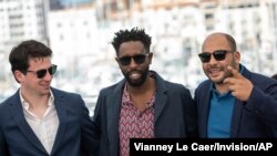 Producer Christophe Barral, from left, director Ladj Ly and producer Toufik Ayadi pose for photographers at the photo call for the film 'Les Miserables' at the 72nd international film festival, Cannes, southern France, May 16, 2019. 