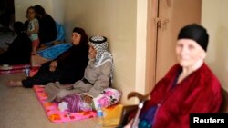 A Christian family, who fled from the violence in Mosul two days ago, stays at a school in Arbil, in Iraq's Kurdistan region, June 27, 2014.