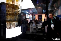 FILE - A man takes a photo of a model of the IBM Q System One quantum computer during the 2020 CES in Las Vegas, Nevada, U.S. January 7, 2020. (REUTERS/Steve Marcus/File Photo)