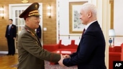 North Korean Defense Minister No Kwang Chol, left, and Russian Defense Minister Andrei Belousov, right, shake hands during their meeting in Pyongyang, North Korea, Nov. 29, 2024. (Vadim Savitsky, Russian Defense Ministry Press Service via AP)