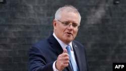 FILE - Australia's Prime Minister Scott Morrison gestures as he leaves 10 Downing street in central London on June 15, 2021.