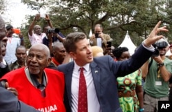 FILE - Secretary General of the Mau Mau War Veterans Association, Gitu wa Kahengeri, left and British High Commissioner to Kenya Christian Turner attend the unveiling of the Mau Mau veteran memorial in Nairobi, Kenya, Sept. 12, 2015.