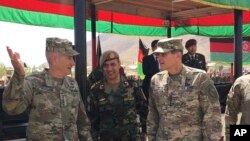 FILE - In this Aug. 20, 2017, photo, U.S. Gen. John Nicholson, top U.S. commander in Afghanistan, left, talks with Col. Khanullah Shuja, commander of the Afghan special operations force, and U.S. Gen. Joseph Votel, head of U.S. Central Command, at Camp Morehead in Afghanistan. 