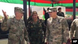 FILE - In this Aug. 20, 2017, photo, U.S. Gen. John Nicholson, top U.S. commander in Afghanistan, from left, talks with Col. Khanullah Shuja, commander of the Afghan special operations force, and U.S. Gen. Joseph Votel, head of U.S. Central Command, at Camp Morehead in Afghanistan. 