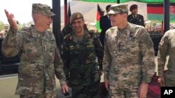 FILE - U.S. Gen. John Nicholson, top U.S. commander in Afghanistan, left, talks with Col. Khanullah Shuja, commander of the Afghan special operations force, and U.S. Gen. Joseph Votel, head of U.S. Central Command, at Camp Morehead in Afghanistan, Aug. 20, 2017.